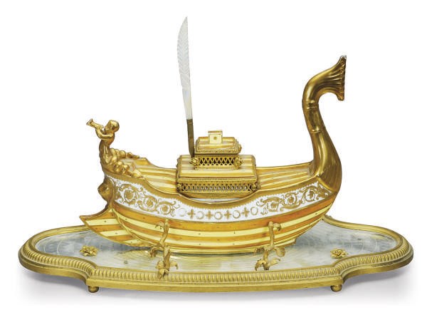 A SEVRES-STYLE PORCELAIN GALLEON-FORM INKWELL AND A GILT-METAL MOUNTED MIRRORED PLATEAU,