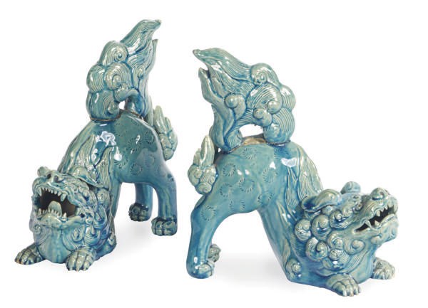 A PAIR OF CHINESE PORCELAIN TURQUOISE GLAZED MODELS OF CROUCHING BUDDHISTIC LIONS,