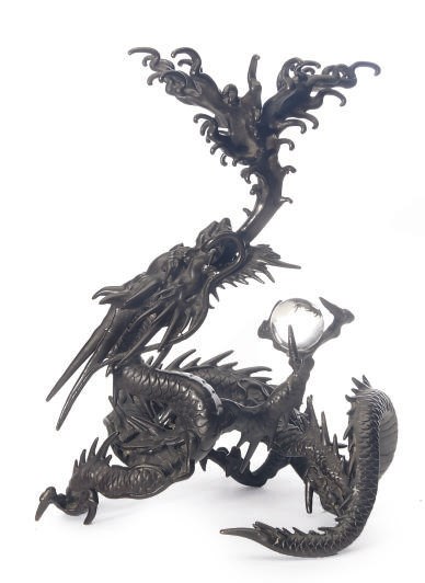 A JAPANESE BRONZE MODEL OF A DRAGON WITH GLASS ORB,