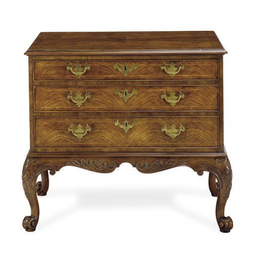 A WALNUT AND FEATHER-BANDED CHEST-OF-DRAWERS,