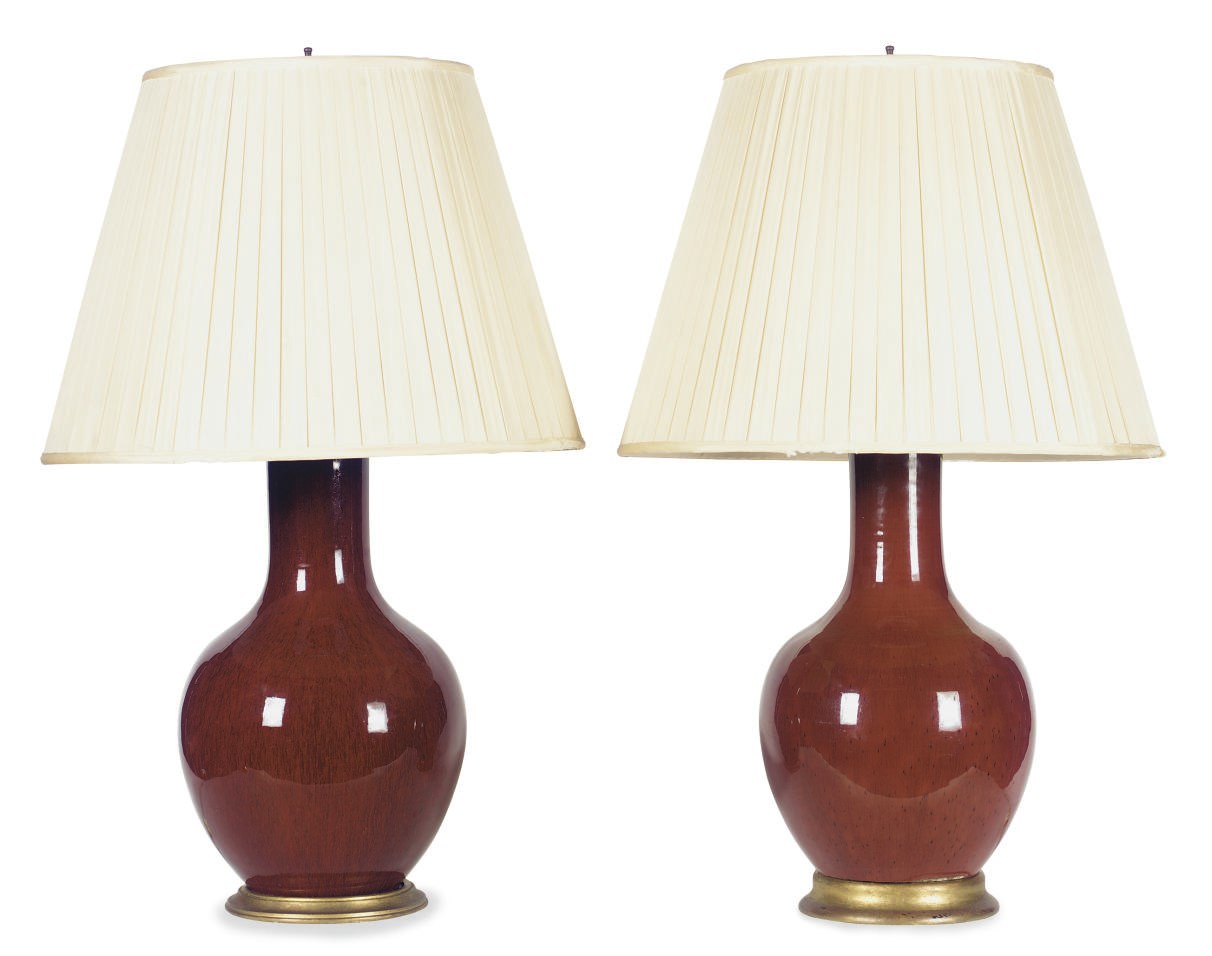 A NEAR PAIR OF SANG DE BOEUF PORCELAIN VASES MOUNTED AS LAMPS,