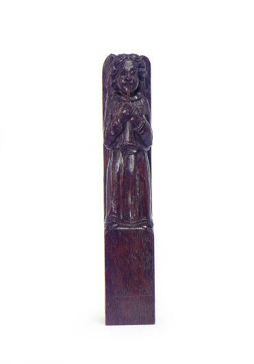 A NORTH EUROPEAN OAK FIGURE OF AN ANGEL BLOWING A TRUMPET,
