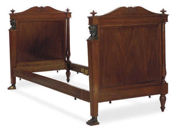 A FRENCH EMPIRE MAHOGANY AND EBONIZED BED,