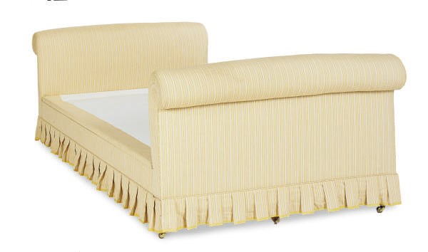 A YELLOW AND WHITE LINEN UPHOLSTERED BED,