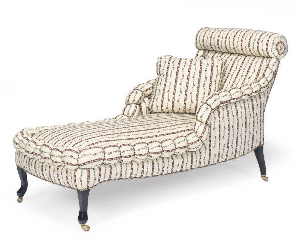 AN EBONIZED AND UPHOLSTERED CHAISE LOUNGE,