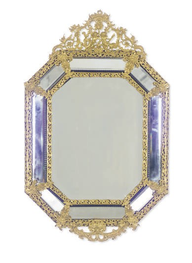 A GILT-METAL AND STAINED-WOOD MIRROR,