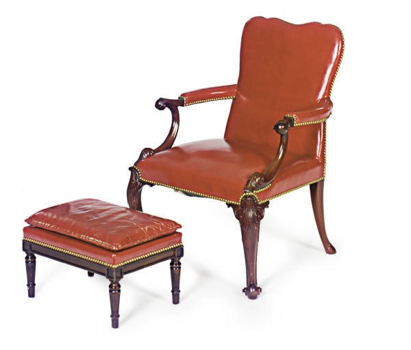 A CARVED MAHOGANY AND RED LEATHER UPHOLSTERED OPEN ARMCHAIR,