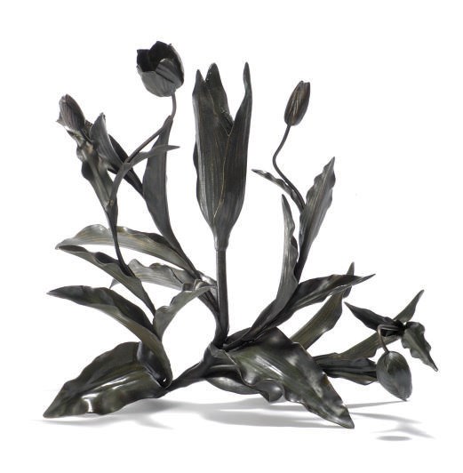 A PATINATED METAL CANDELABRUM,