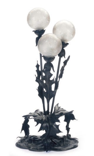 A PATINATED METAL AND CUT-GLASS TABLE LAMP,