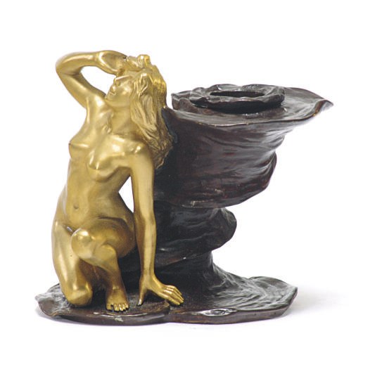 A FRENCH PATINATED AND GILT-BRONZE FIGURAL CANDLESTICK,