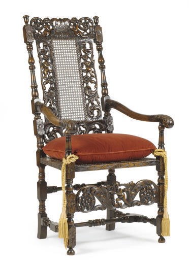 A CONTINENTAL WALNUT AND CANED ARMCHAIR,