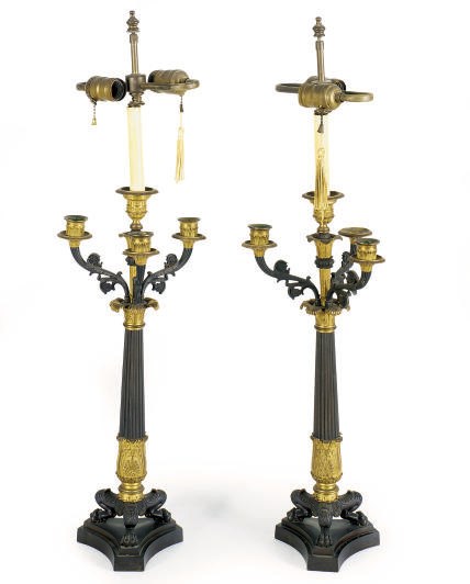 A PAIR OF PATINATED AND GILT-BRONZE CANDELABRAS MOUNTED AS TABLE LAMPS,