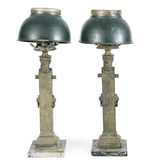 A PAIR OF PATINATED BRONZE TERM FIGURE CANDLESTICKS LATER MOUNTED AS TABLE LAMPS,