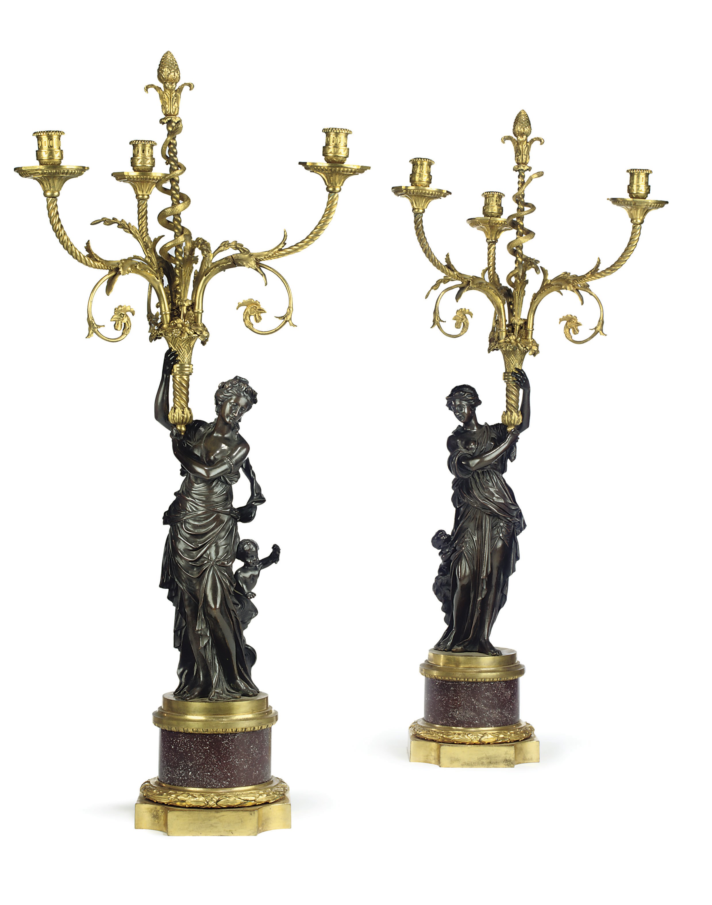 A PAIR OF FRENCH ORMOLU, PATINATED BRONZE AND PORPHYRY THREE-BRANCH CANDELABRA