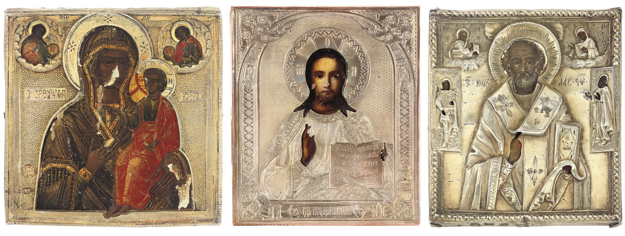 A TRAVELLING ICON OF CHRIST PANTOKRATOR, ONE OF SAINT NICHOLAS WITH PATRON SAINTS AND ANOTHER OF THE MOTHER OF GOD OF SMOLENSK; ALL THREE INCLUDING OKLADS