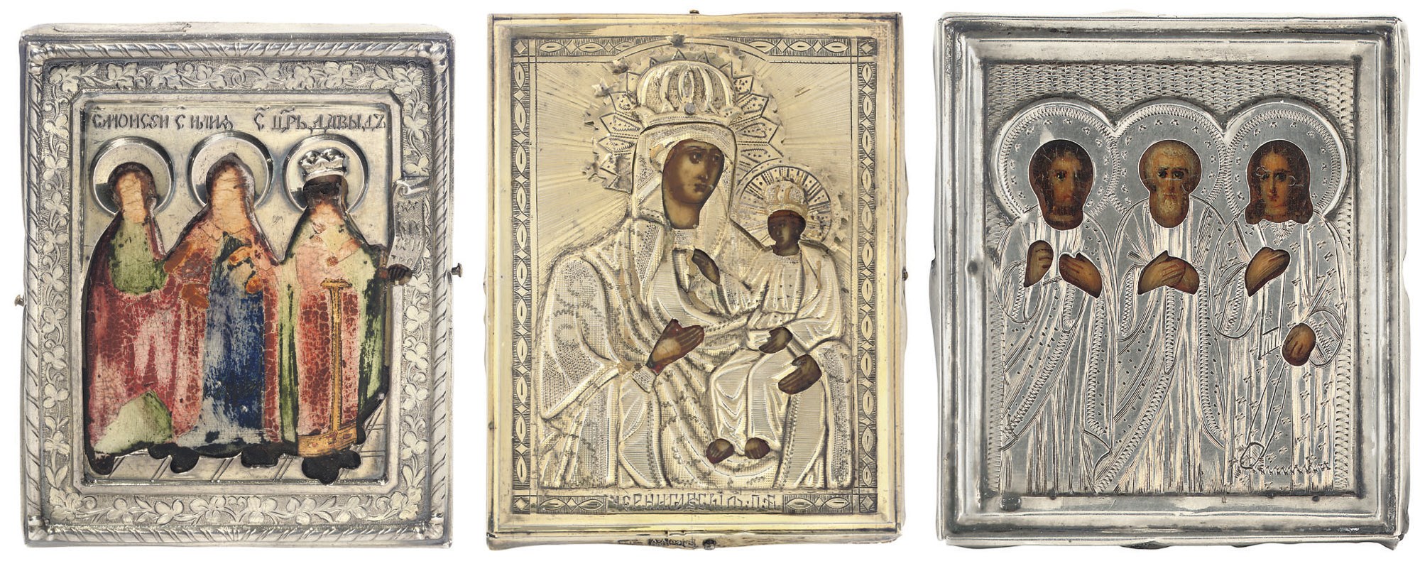 A GILT ICON OF CHERNIGOVSKAYA MOTHER OF GOD, AN ICON OF THREE SAINTS (SOME LOSSES) AND A MINIATURE ICON OF THREE SAINTS; ALL THREE TRAVELLING ICONS WITH OKLADS