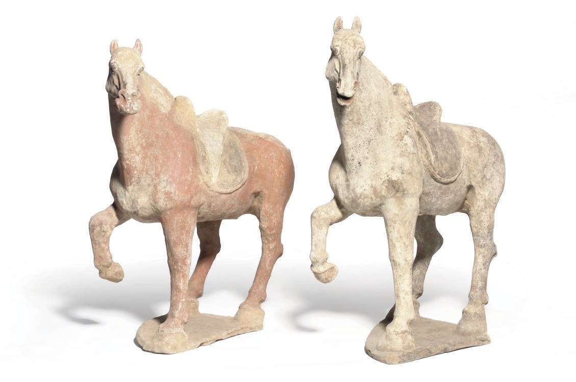 TWO CHINESE POTTERY PRANCING HORSES
