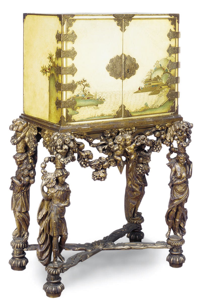 A GILT-HEIGHTENED CREAM JAPANNED CABINET ON GILTWOOD COMPOSITION STAND