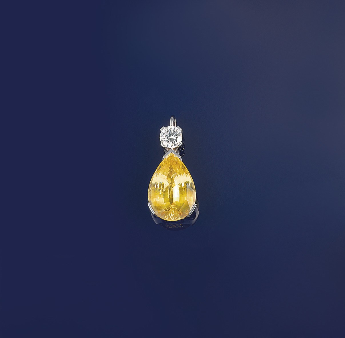 A yellow sapphire and diamond pendant