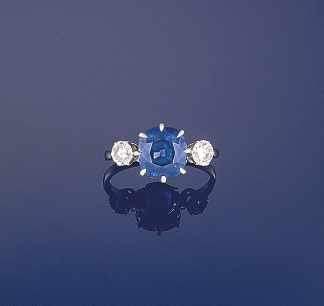 A sapphire and diamond three stone ring