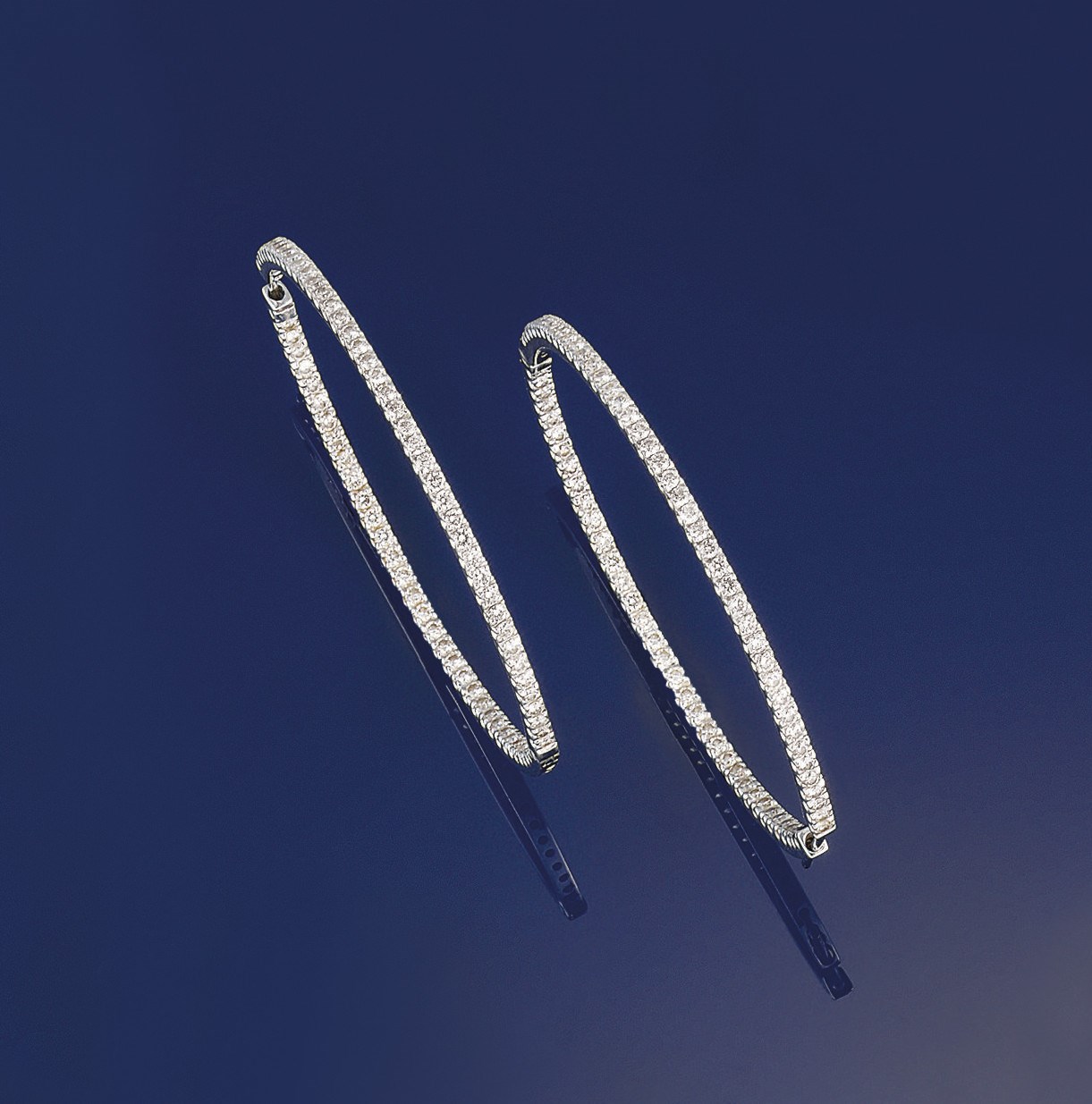 A pair of diamond hoop earrings