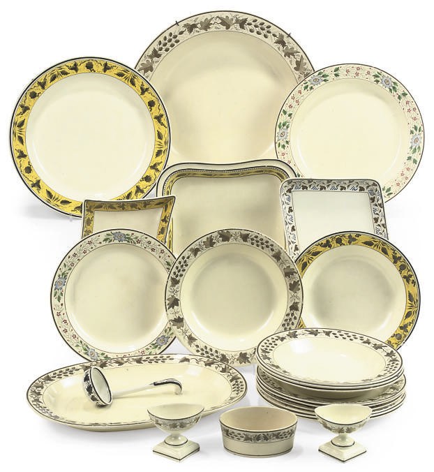 A GROUP OF ENAMELLED CREAMWARE DINNERWARES