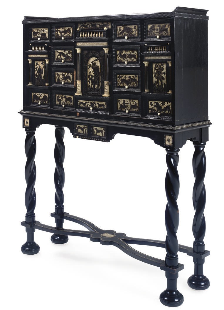 A BONE-INLAID EBONY AND EBONISED CABINET ON STAND
