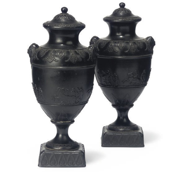 A PAIR OF ENGLISH BLACK BASALT VASES AND DOMED COVERS
