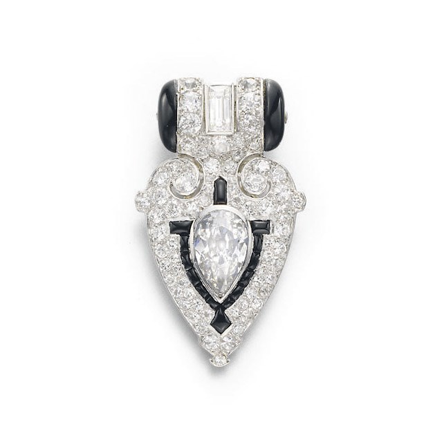 AN ART DECO DIAMOND AND ONYX DRESS CLIP, BY CARTIER