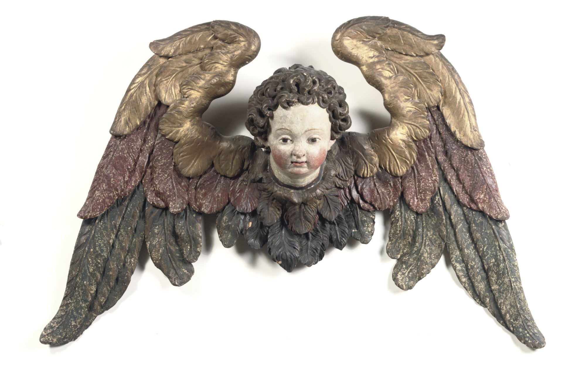 A PARCEL-GILT AND POLYCHROME CARVED FIGURE OF A CHERUB