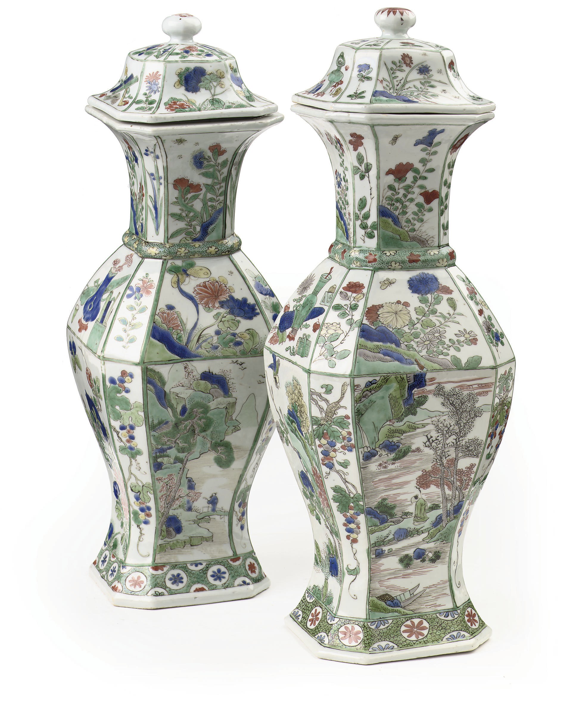 A matched pair of Chinese famille verte octagonal baluster vases and covers