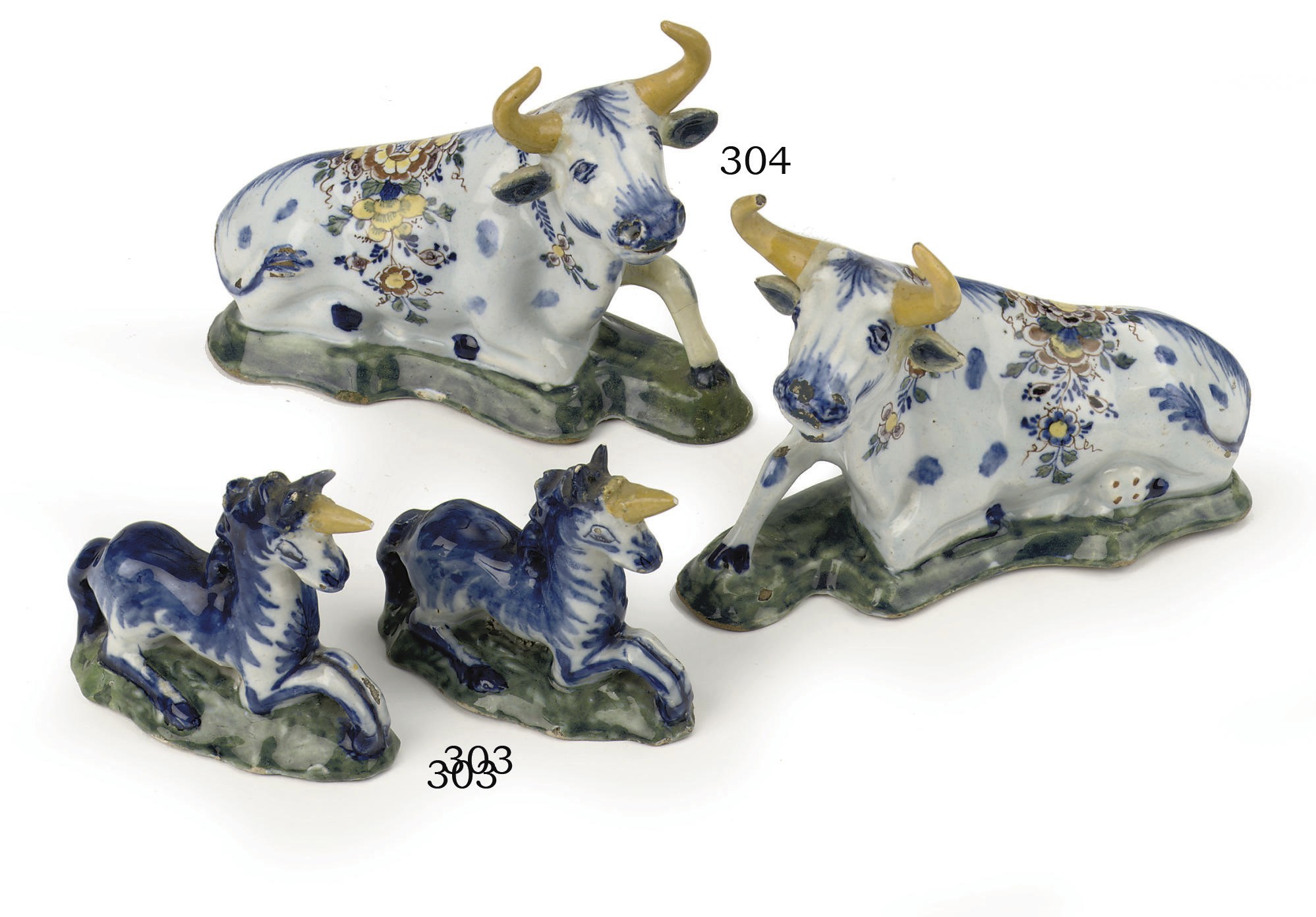 A pair of Dutch Delft polychrome models of recumbent cows