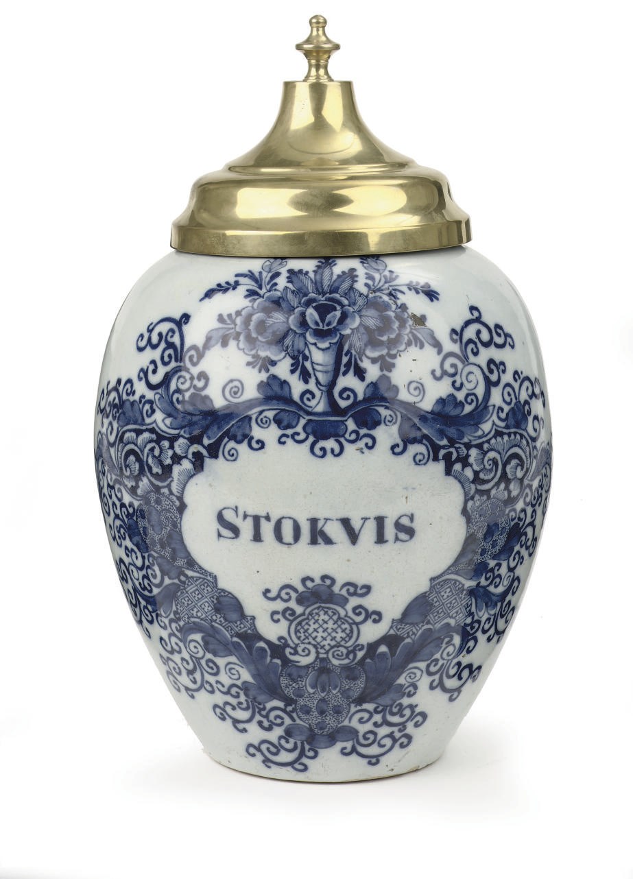 A Dutch Delft blue and white tobacco jar and a brass cover