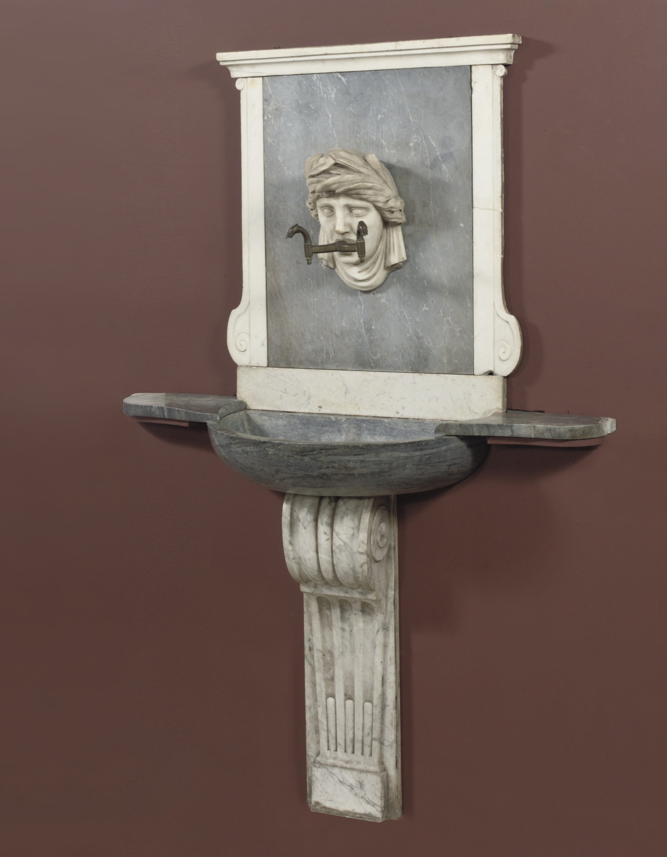 A NORTH EUROPEAN WHITE AND BLEU TURQUIN MARBLE WALL FOUNTAIN