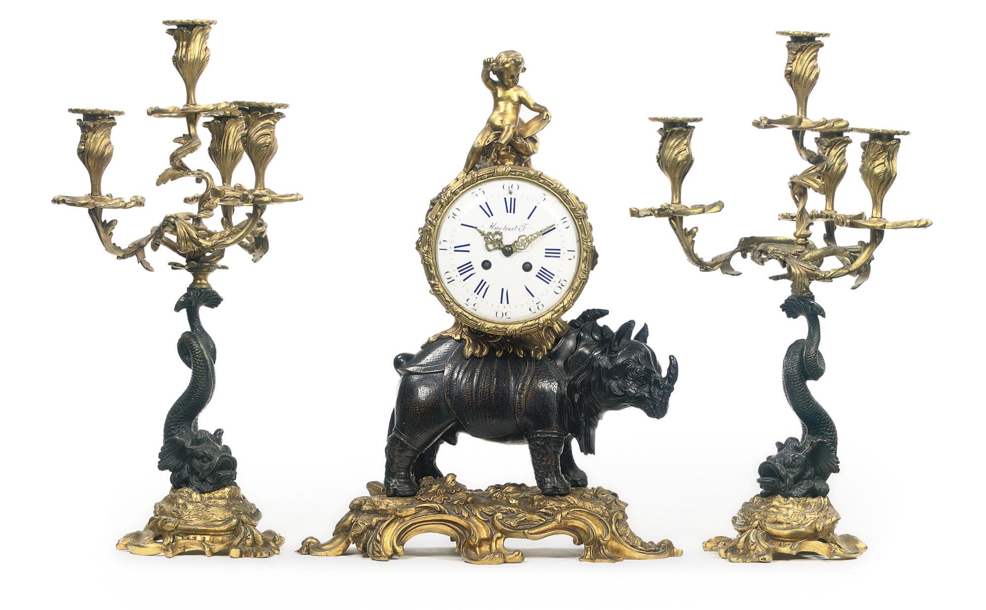 A FRENCH ORMOLU AND PATINATED BRONZE THREE PIECE CLOCK GARNITURE