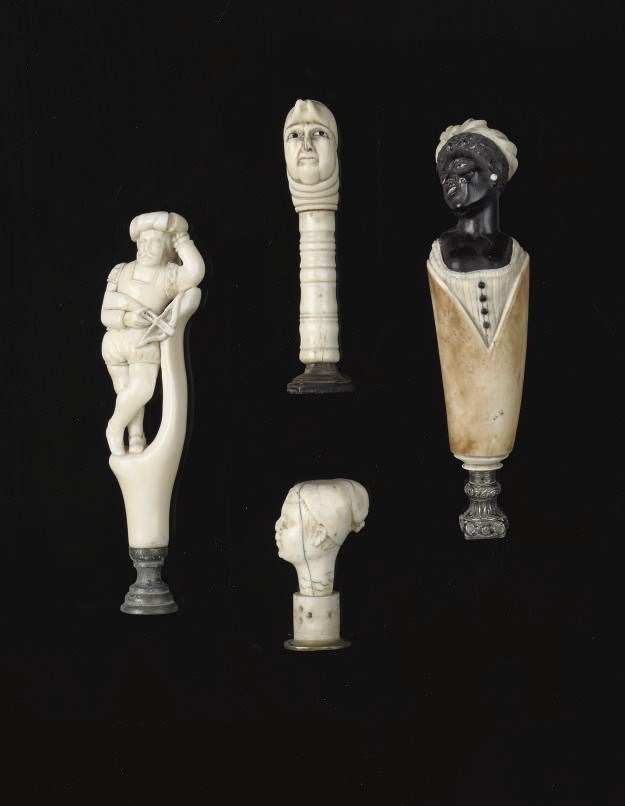 THREE CARVED IVORY SEALS AND ONE CARVED EBONY AND BONE