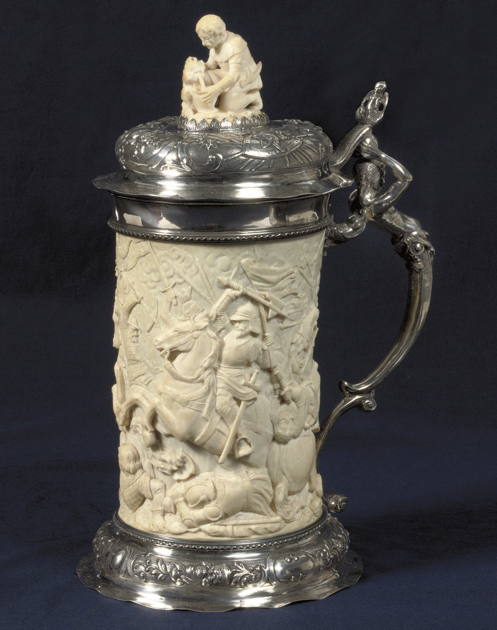 A GERMAN SILVER-MOUNTED CARVED IVORY TANKARD