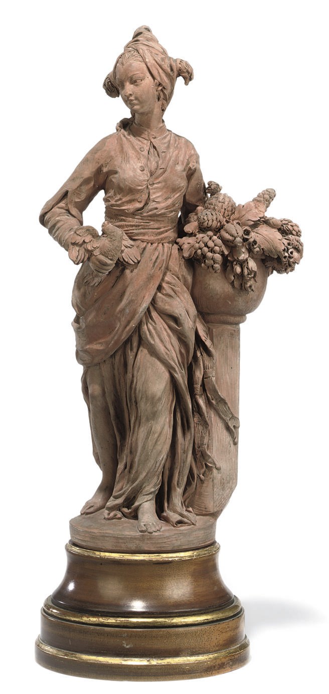 A FRENCH TERRACOTTA FEMALE FIGURE