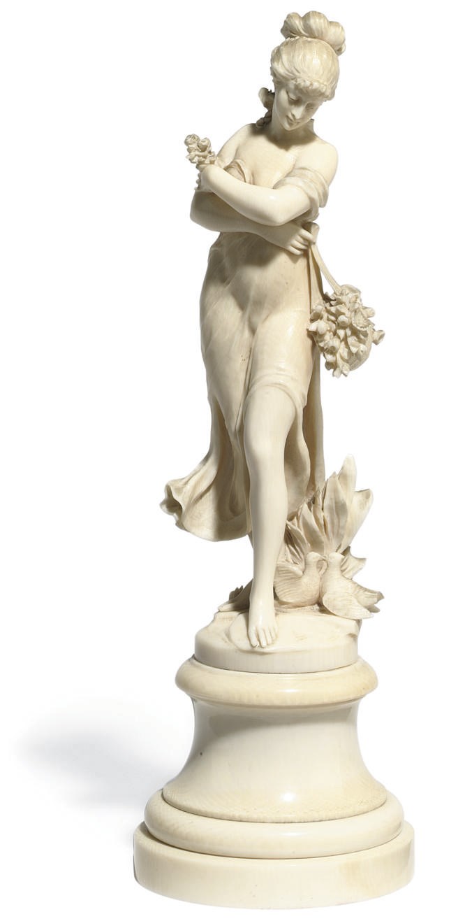 A FRENCH IVORY MODEL OF A MAIDEN EMBLEMATIC OF SPRING