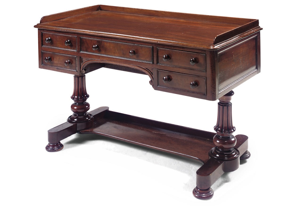 AN EARLY VICTORIAN MAHOGANY WRITING TABLE