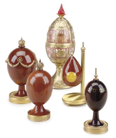 A RUSSIAN SILVER-GILT MOUNTED EGG AND A GROUP OF FOUR GILT-METAL MOUNTED EGGS,