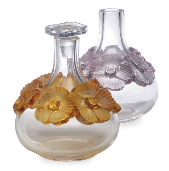 TWO FRENCH GLASS DECANTERS MOLDED WITH FLOWERS AND A STOPPER,