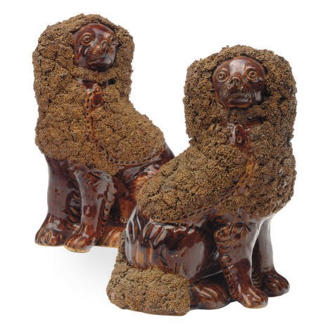 A PAIR OF AMERICAN GLAZED EARTHENWARE MODELS OF SPANIELS,