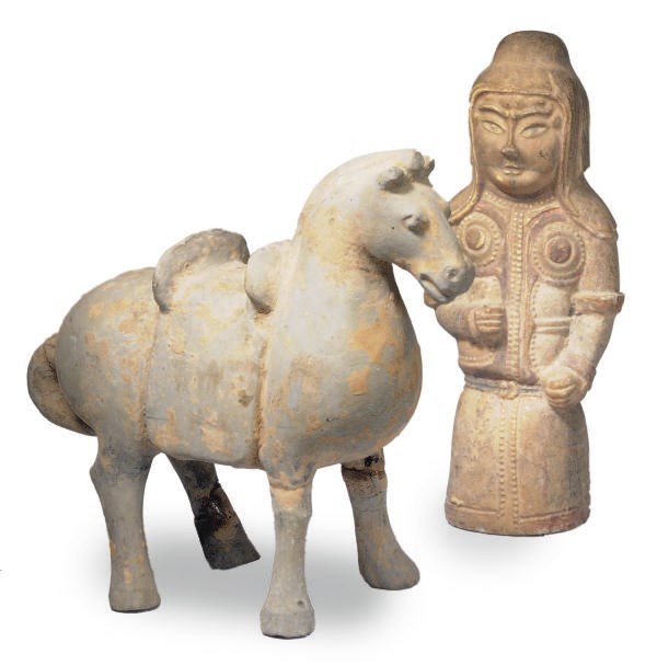 A CHINESE POTTERY HORSE AND A POTTERY TOMB GUARD,