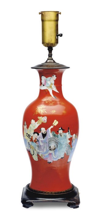 A CHINESE PORCELAIN RED GROUND FAMILLE ROSE ENAMELED VASE MOUNTED AS A LAMP,