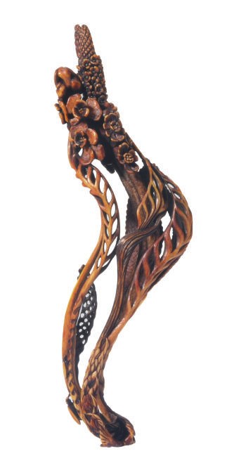 A JAPANESE STAINED IVORY MODEL OF A FLOWERING PLANT,