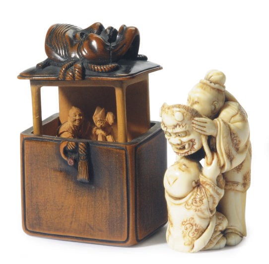 A JAPANESE CARVED IVORY NETSUKE AND A STAINED WOOD BOX AND COVER,**