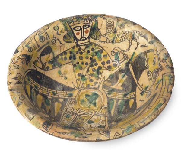 A NISHAPUR POTTERY BOWL DECORATED WITH A KING ON HORSEBACK,**