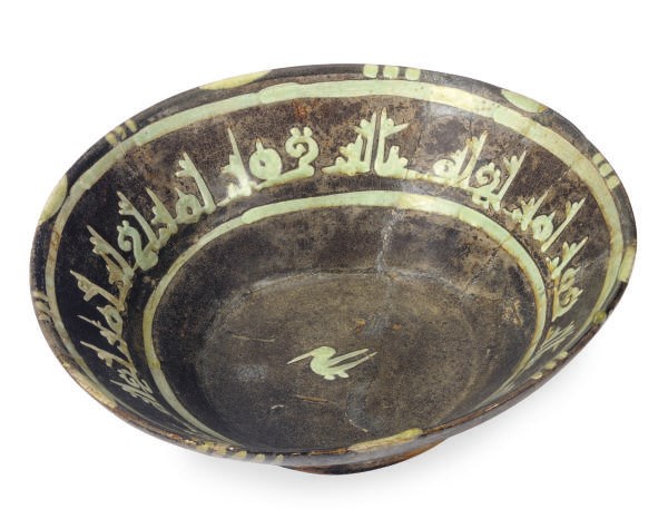 A NISHAPUR GREEN AND BROWN-GLAZED POTTERY BOWL,