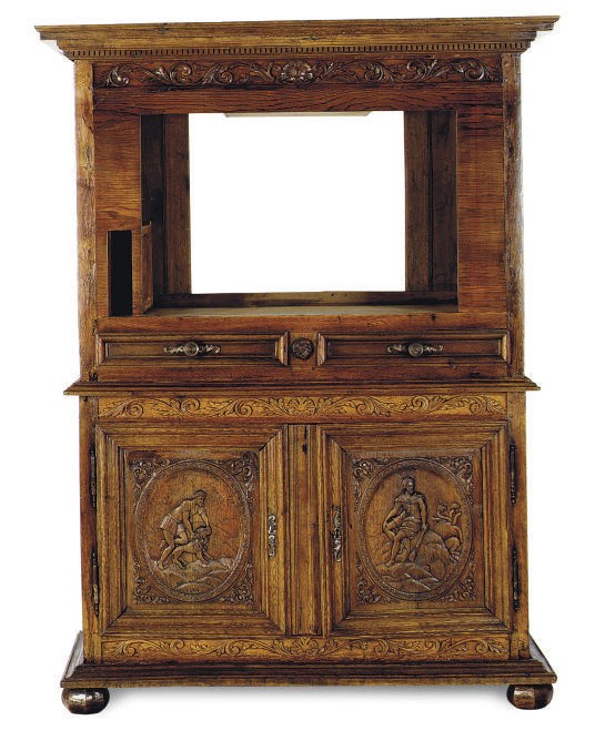 A CONTINENTAL CARVED OAK CABINET,